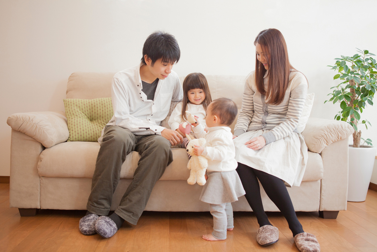 Japanese family sitting on sofa